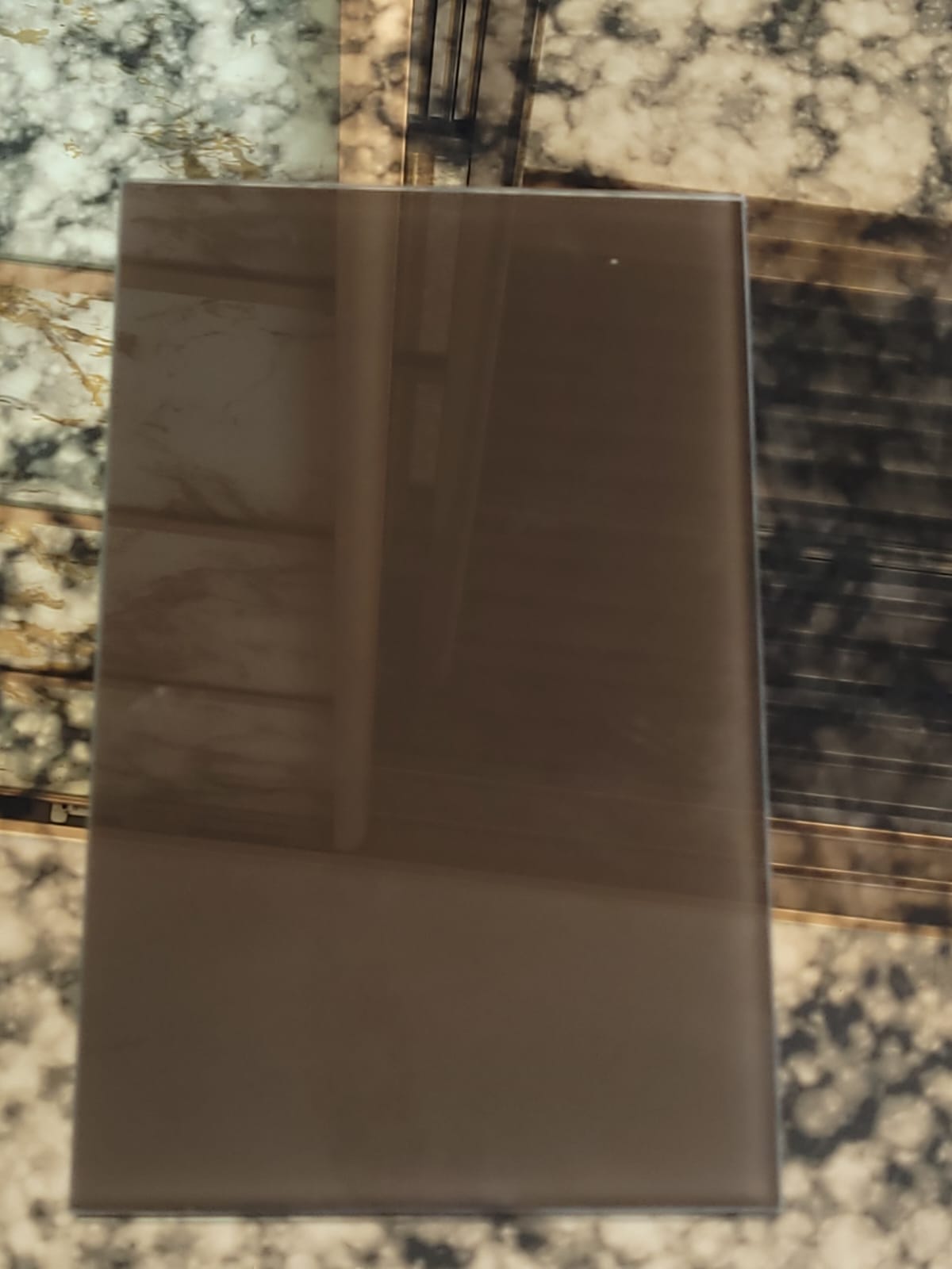 Bronze-tone glass — A smooth, reflective bronze-toned finish.