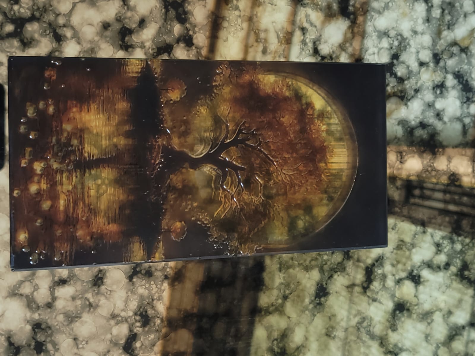 Golden tree art glass — A tree silhouette within a warm, circular landscape.