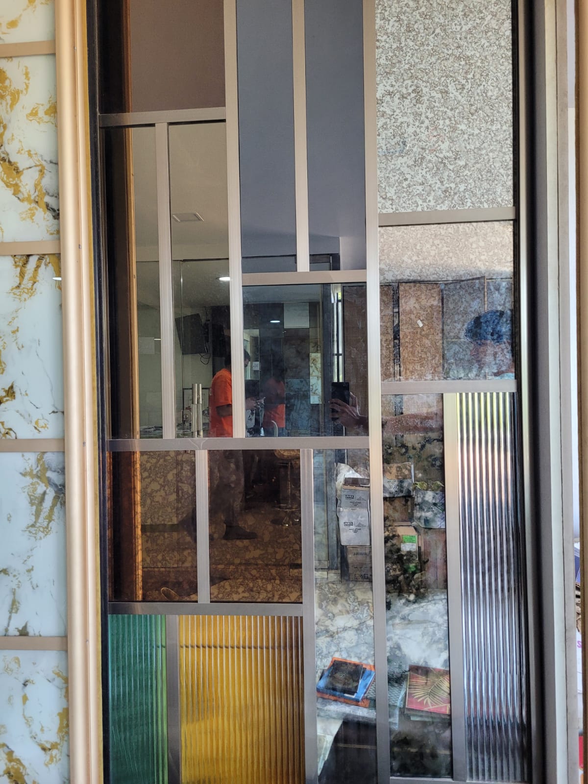 Mixed-finish display panel — An arrangement of reflective, textured and coloured glass finishes.